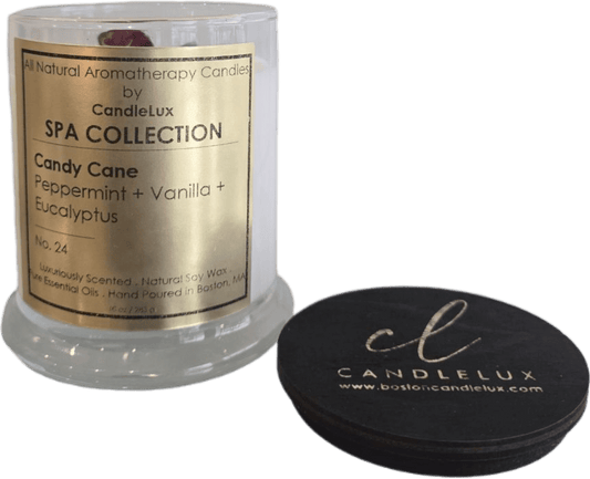 Picture of soy wax candle in a clear glass round vessel with a CandleLux Spa Collection Fraser Fir gold foil label on the front. 